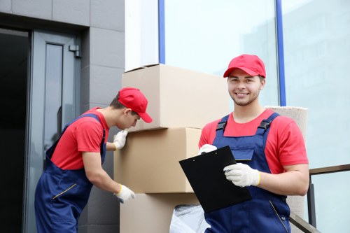 Moving van and packed boxes for Removals Brondesbury in a residential street