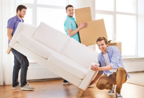 Professional movers handling furniture in NW London