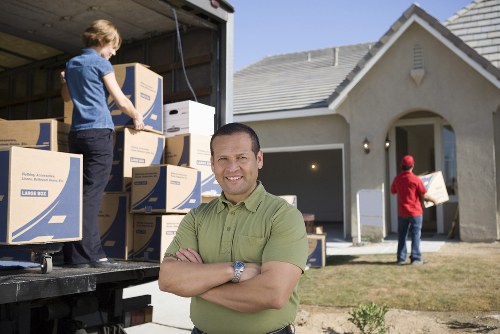 Professional movers loading furniture into a van in Fulham