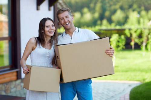 Professional movers handling fragile items and boxes